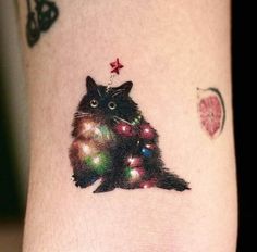 a cat with christmas lights on it's leg is seen in this image,