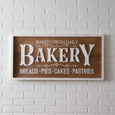 a wooden sign that reads baked fresh daily bakery breads - pies - cakes - pastries