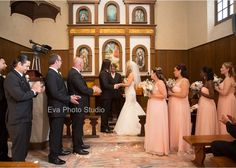 a bride and groom are getting married at the alter