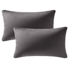 two grey velvet pillows on a white background