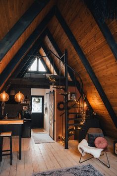 a loft with wooden floors and vaulted ceiling