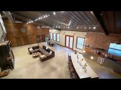 an aerial view of the inside of a building with tables, couches and televisions