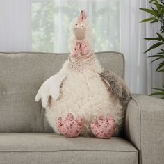 a stuffed chicken sitting on top of a couch