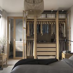 a bedroom with a bed, dresser and closet