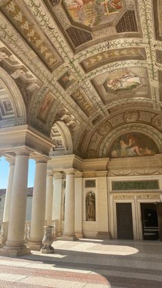 an ornate building with columns and paintings on the ceiling