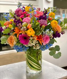 a vase filled with colorful flowers on top of a table