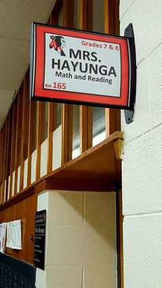 a sign hanging from the side of a building that reads mrs hayunga math and reading