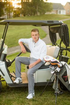 a man sitting on top of a golf cart next to a bag of golf clubs