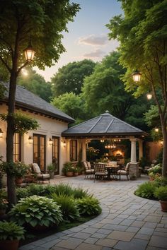 an outdoor dining area in the middle of a garden with lots of trees and plants