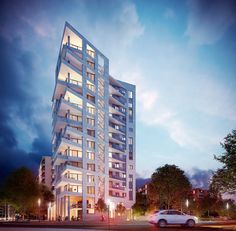 a tall white building sitting on the side of a road