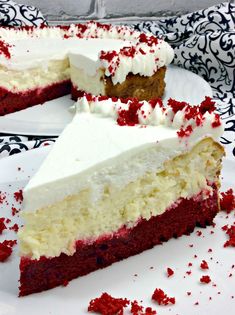 a piece of cake with white frosting and red sprinkles