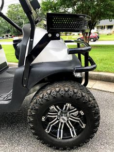 the golf cart is parked on the side of the road