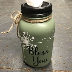 a green mason jar with a tissue paper dispenser on it that says, please you