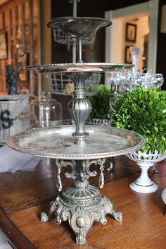 a three tiered cake plate on top of a wooden table