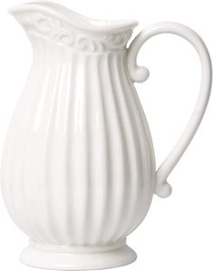 a white ceramic pitcher on a white background