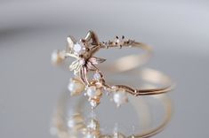 About A romantic work of architectural beauty, the Sugar Plum Fairy ring was directly inspired by the beautiful Russian prima ballerina Nina Kaptsova during her performance of the "Dance of the Sugar Plum Fairy". As twinkling and delectably lovely as the dainty sprite herself, dancing from one dew-dropped flower petal to another, this graceful ring is an homage to the delicate filigree of movements in her dance. Description Made by hand in our Montreal studio Available in 14k gold Featuring 1 2. Fairy Rings, Sofia Zakia, Fairy Ring, Prima Ballerina, Sugar Plum Fairy, Fairy Wedding, Fairy Jewelry, Hot Jewelry, Flower Petal