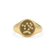 a gold signet ring with stars on it