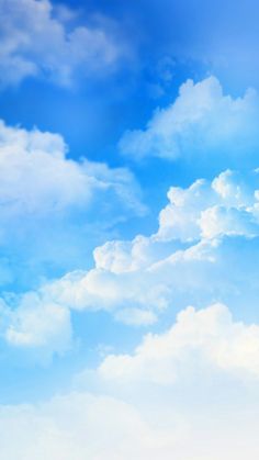 the airplane is flying high in the blue sky with white clouds above it on a sunny day