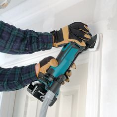 a person using a power tool on a wall