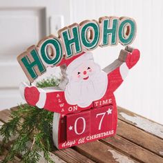 a wooden sign that says ho hoo on time with santa claus in the center