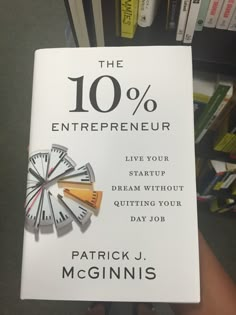 a book about the 10 % experience by patrick j mcginnis is being held in front of a bookshelf