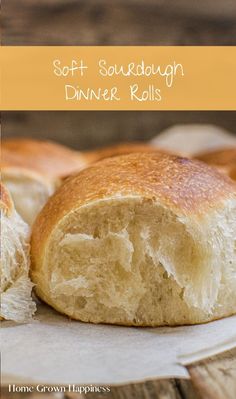 a loaf of sourdough dinner rolls sitting on top of a piece of parchment paper