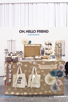 a table that has some bags on it and other items in front of it with the words oh, hello friend