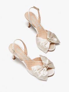 For the bride-to-be: Toss the bouquet in that magical white dress and these satin slingback pumps, done in a d'orsay style and adorned with pearls and jewels to boot. | Kate Spade Happily Slingback Pumps, Ivory Bridal Kate Spade Bridal, Kate Spade Heels, Ivory Pumps, Fun Wedding Shoes, Ivory Bridal, Bow Heels, Rhinestone Bow, Satin Pumps, Wedding Heels