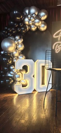 a room with balloons and a sign that says 30th