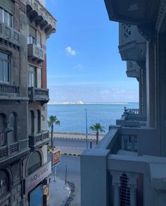 the view from an apartment building looking out at the ocean and buildings in front of it