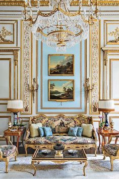 an ornate living room with blue walls and gold trimmings