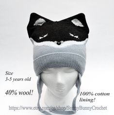 a knitted hat with an image of a cat's head on top of it