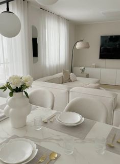 a dining room table is set with plates and silverware