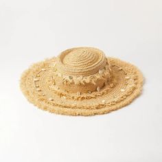 Embrace the sun while keeping cool and stylish with our Chic Raffia Sun Hat. Handcrafted from high-quality raffia, this hat is a must-have accessory for any beach goer or outdoor enthusiast looking to combine fashion with functionality. The elegant shell decoration adds a touch of seaside charm, making it a standout addition to your summer wardrobe. Key Features Sun Protection: Enjoy your day in the sun without the worry, as our hat offers excellent protection against harmful UV rays. Material: Made from 100% natural raffia, known for its durability and breathability. Design: Features a solid pattern with a casual style that complements any outfit. Seasonality: Perfect for spring and summer, providing both comfort and style in warm weather. Product Benefits Versatile Fashion: Its neutral c Beige Beachy Straw Hat For Beach, Palm Leaf Sun Hat For Beach In Spring, Beachy Beige Straw Hat For Beach Season, Woven Hats For Beach Vacation, Woven Sun Panama Hat For Vacation, Woven Toquilla Straw Sun Hat For Vacation, Woven Palm Leaf Sun Hat For Vacation, Beige Straw Hat For Beach Season, Toquilla Straw Hat For Vacation In Beachwear Style