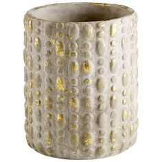 a white vase with gold dots on it