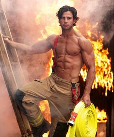 a shirtless man holding a yellow fire hose