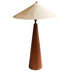 a wooden table lamp with a white shade on it's top and bottom part