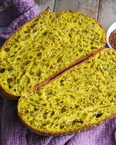 two slices of bread on a purple towel next to bowls of mustard and seasoning