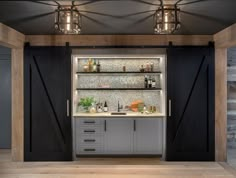 a kitchen area with sliding doors and shelves on the wall, surrounded by wood flooring