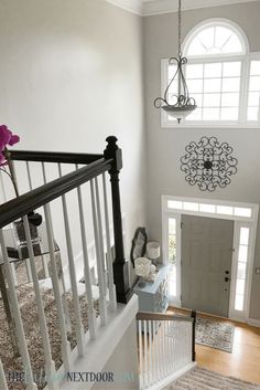 an overhead view of a staircase leading up to a front door with a chandelier hanging from the ceiling