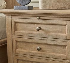 a close up of a wooden dresser with drawers