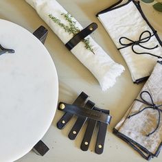 the table is decorated with black and white napkins, scissors, and other decorative items