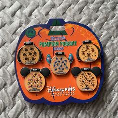 there are six mickey mouse pumpkins in the box on the bed with other items