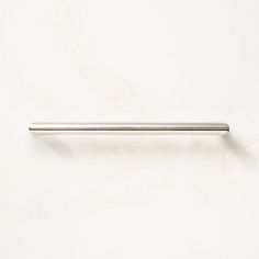 a stainless steel handle on a white wall