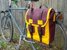 a purple and yellow bag sitting on the back of a bike