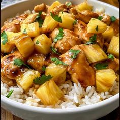 a white bowl filled with rice and pineapple chicken