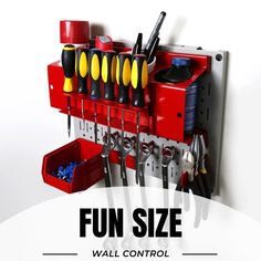 there is a red tool rack with tools hanging on it's side and other tools attached to the wall