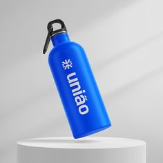 a blue water bottle on top of a white pedestal