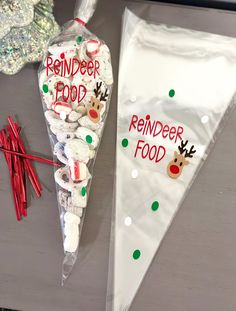 a plastic bag with reindeer food on it next to some strawberries and candy sticks