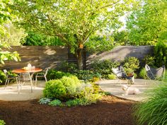 an outdoor patio with chairs, table and hammock in the middle of it